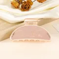 Close-up of matte pink shark hair claw clip with Good Luck text and sparkling rhinestones - 9cm / Pink
