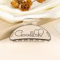 Detail of cream shark hair clip with GoodLuck lettering and shimmering rhinestones - 9cm / Khaki
