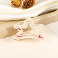 Detailed close-up of a star-shaped hair claw clip with red and white striped patterns - Red