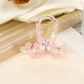 Detail of pink acrylic hair claw clip with bow accents and inlaid gemstones - Pink