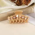 Detailed view of beige resin hair claw clip with crystal hearts and bow decorations - Khaki
