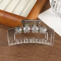 Detail of transparent floral hair claw clip with crystal center and matte petals - Gray