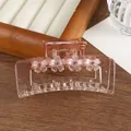Detail of pink transparent acrylic hair claw clip with floral patterns and pink rhinestones - Pink