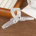 Detailed view of the large floral hair claw with sparkling rhinestones and pearl finish - Gray