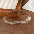 Detail shot of a translucent amber cloud hair claw clip with a wavy geometric design - Gradient Coffee