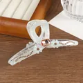 Close-up of pearl white floral claw clip with champagne rhinestones and crystals - Sky Blue