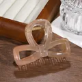Close-up of glitter bow hair claw clip in gradient pink orange with gold metal spring - Coffee and Orange