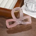Close-up of glitter bow hair claw clip with transparent pink gradient and metal spring - Nude And Pink