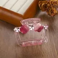 Detail of pink transparent hair claw clip with floral and clover accents on wood - 6.5cm / Rose Red