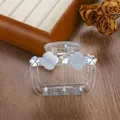 Detailed view of a transparent acrylic hair claw clip with floral accents and gold spring - 6.5cm / Sky Blue
