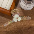 Detail of a large acrylic hair claw clip with colorful beads and a green flower motif - Green (11cm)