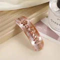 Detail of marble acetate hair clip with delicate flowers and champagne crystals - Pink