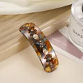 Close-up of tortoiseshell acetate spring hair clip with brown flowers and crystals - Blue