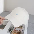 Detail of distressed brim and embroidery on a vintage style off-white baseball cap - Adjustable / Off White