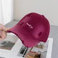 Close-up of distressed burgundy baseball cap featuring white smile embroidery and vintage tears - Adjustable / Burgundy