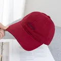 Close-up of deep red canvas baseball cap with blue letter embroidery and neat stitching - Adjustable / Burgundy