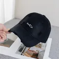 Close-up of black baseball cap with white Smile embroidery and distressed ripped details - Adjustable / Black