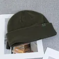 Detail of dark green wool knit beanie with ribbed texture and woven logo patch on cuff - One Size(Elastic) / Army Green
