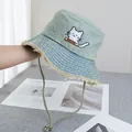 Detail view of washed denim bucket hat with cat embroidery and frayed edges - Adjustable / Light Blue
