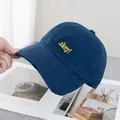Detailed close-up of dark blue baseball cap featuring bright yellow .okey! embroidery - Adjustable / Navy Blue