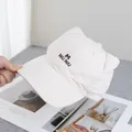 Detailed close-up of cat ear design and letter embroidery on beige cotton baseball cap - Adjustable / Beige