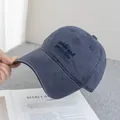 Close-up of blue embroidery on a washed cotton baseball cap with a vintage look - Adjustable / Grey Blue
