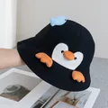 Detail of cute penguin bucket hat with 3D blue fish ornament and orange webbed feet - Adjustable / Black