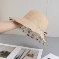Detail of reversible khaki sun hat showing floral inner lining and adjustable straps - Reversible / Double Sided Floral Style / Khaki