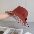 Detail of terracotta sun hat showing floral lining and adjustable bow strap design - Reversible / Double Sided Floral Style / Brick Red