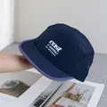 Detailed texture of lightweight ripstop nylon camping hat with embroidered logo - Navy Blue