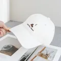 Detailed embroidery of a coffee bean and script on a beige cotton baseball cap - Adjustable / Off White