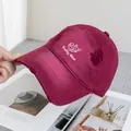 Close-up of embroidered letters and distressed ripped details on a burgundy baseball cap - Adjustable / Burgundy