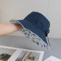 Detailed close-up of blue sun hat with floral lining and adjustable bow strap - Reversible / Double Sided Floral Style / Navy Blue