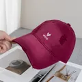 Close-up of wine red baseball cap featuring distressed holes and hello heart embroidery - Adjustable / Burgundy
