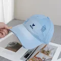 Detailed view of light blue denim baseball cap with distressed holes and heart embroidery - Adjustable / Blue