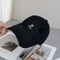 Close-up of black distressed baseball cap with white Hello and heart embroidery detail - Adjustable / Black