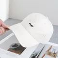 Close-up of plaid baseball cap with black Happy embroidery and curved brim detail - Adjustable / Beige