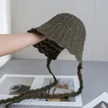 Detail of olive green knit bucket hat featuring hollow crochet pattern and wavy brim design - Coffee / M (56-58cm)