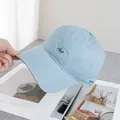Detail of light blue cotton baseball cap featuring dark blue Act embroidery and side stitching - Adjustable / Blue