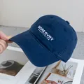 Close-up of white letter embroidery on a navy cotton twill baseball cap with curved brim - Adjustable / Navy Blue
