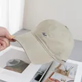 Detailed embroidery of blue Art lettering on a beige cotton baseball cap with soft texture - Adjustable / Khaki