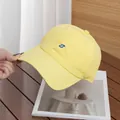 Close-up of blue S embroidery on a bright yellow quick-dry lightweight baseball cap - Adjustable / Yellow
