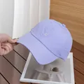 Detailed view of lavender baseball cap with silver S embroidery and quick-dry texture - Adjustable / Purple