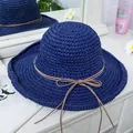 Close-up of dark blue woven straw hat with a brown ribbon bow on a white vanity - M(56-58cm) / Navy Blue
