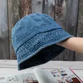 Close-up of vintage washed denim bucket hat with detailed stitching and durable cotton texture - Adjustable / Light Blue