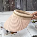 Detail of hand-woven straw visor hat with textured brim and dual-tone strap - Adjustable / Pink