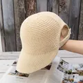 Detail view of the wide-brim knit sun hat with a unique ponytail opening at the back - Adjustable / Beige