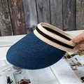 Detail of blue straw sun visor with striped headband showing texture and open-top design - Adjustable / Navy Blue
