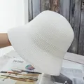 Detail of white finely woven straw bucket hat with textured spiral pattern and round top - Adjustable / White