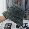 Detail of washed cotton bucket hat showing metal eyelets and reinforced brim stitching - M / Green